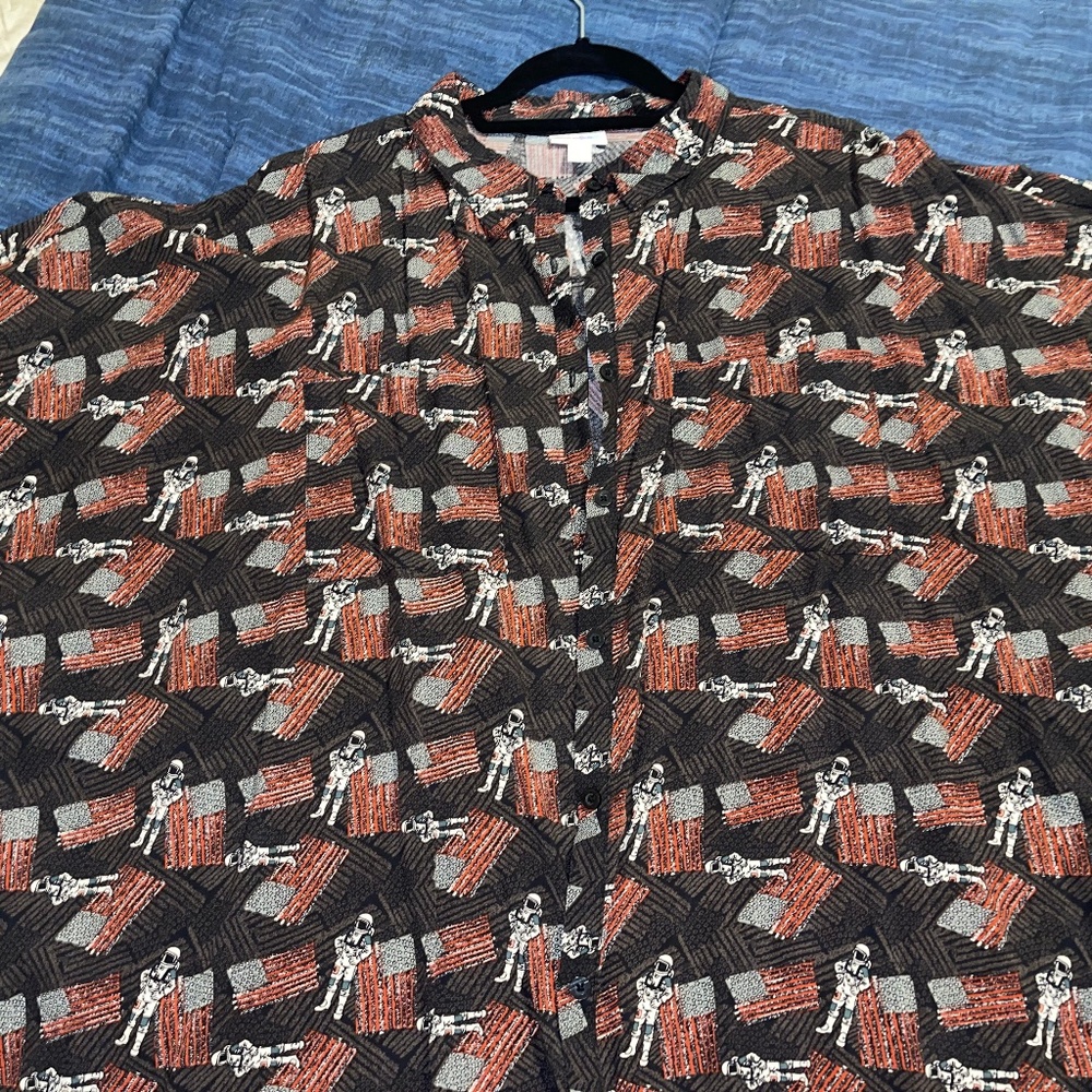 Botton down raglan sleeve shirt.  Decorated with Astronauts & flags.